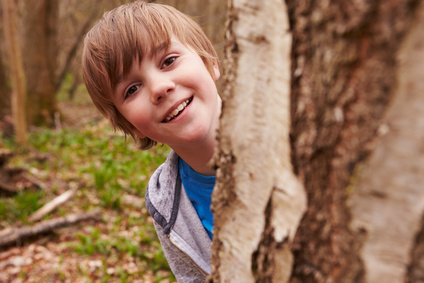 Portrait Of Boy Playing Game In Forest